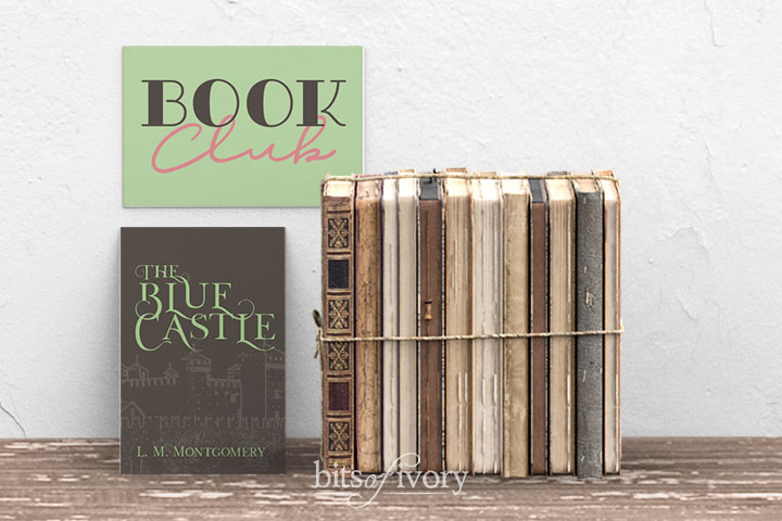 Book club sign with stack of books and cover of The Blue Castle by L. M. Montgomery