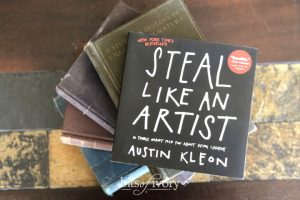 Steal Like an Artist Book by Austin Kleon on top of a stack of books